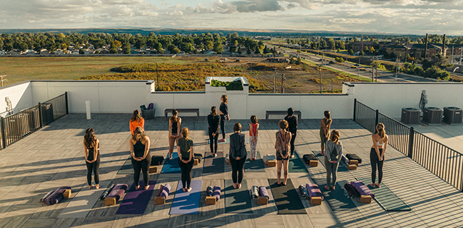 Group doing yoga on rooftop